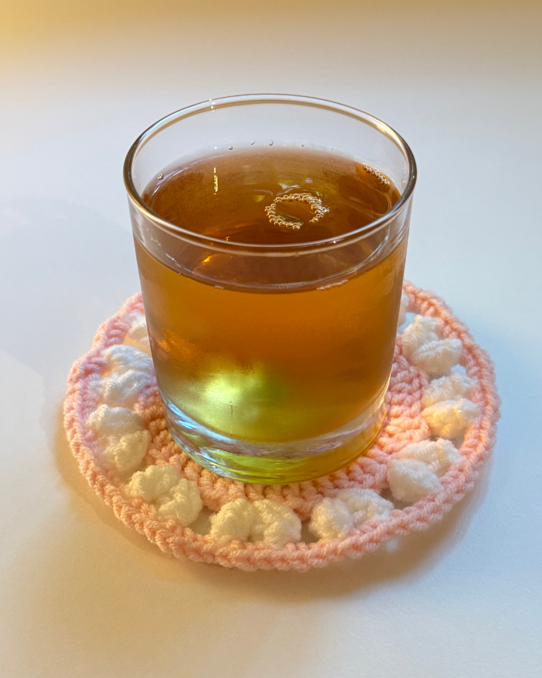 apple-juice-drink-on-a-crochet-coaster-pink-with-white-hearts.png