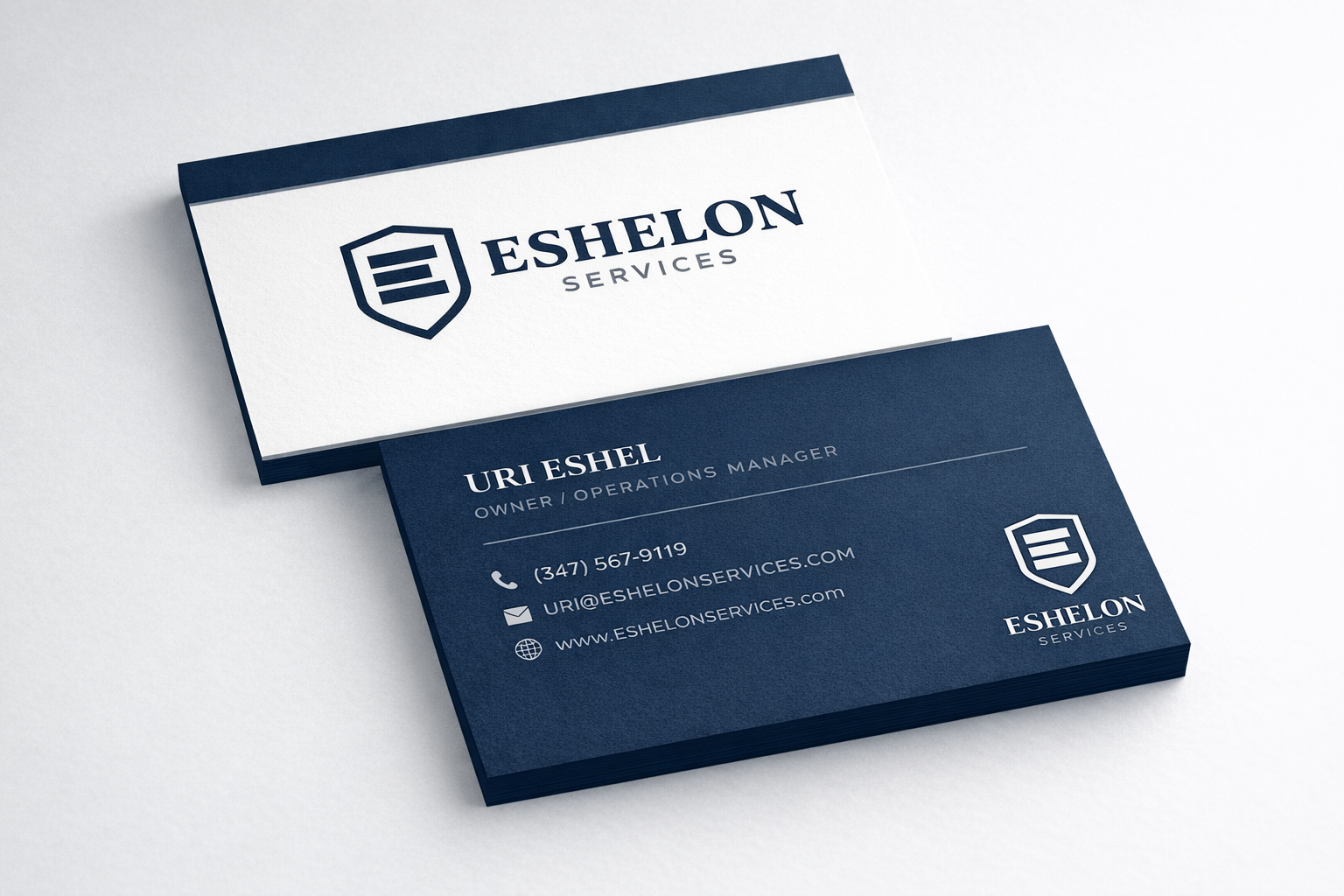 Business card for Eshelon Services, featuring the logo and contact details of Uri Eshel, owner and operations manager, on a dark blue background.