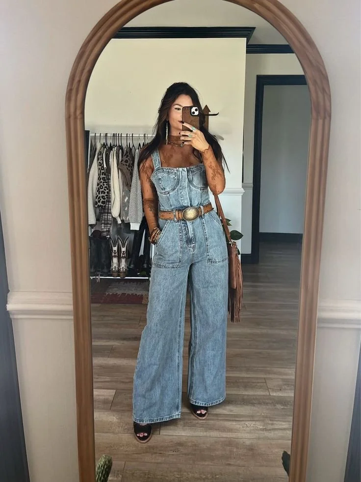 Denim jumpsuit with statement belt creating a bold and modern take on western outfits 2026 fashion.jpeg