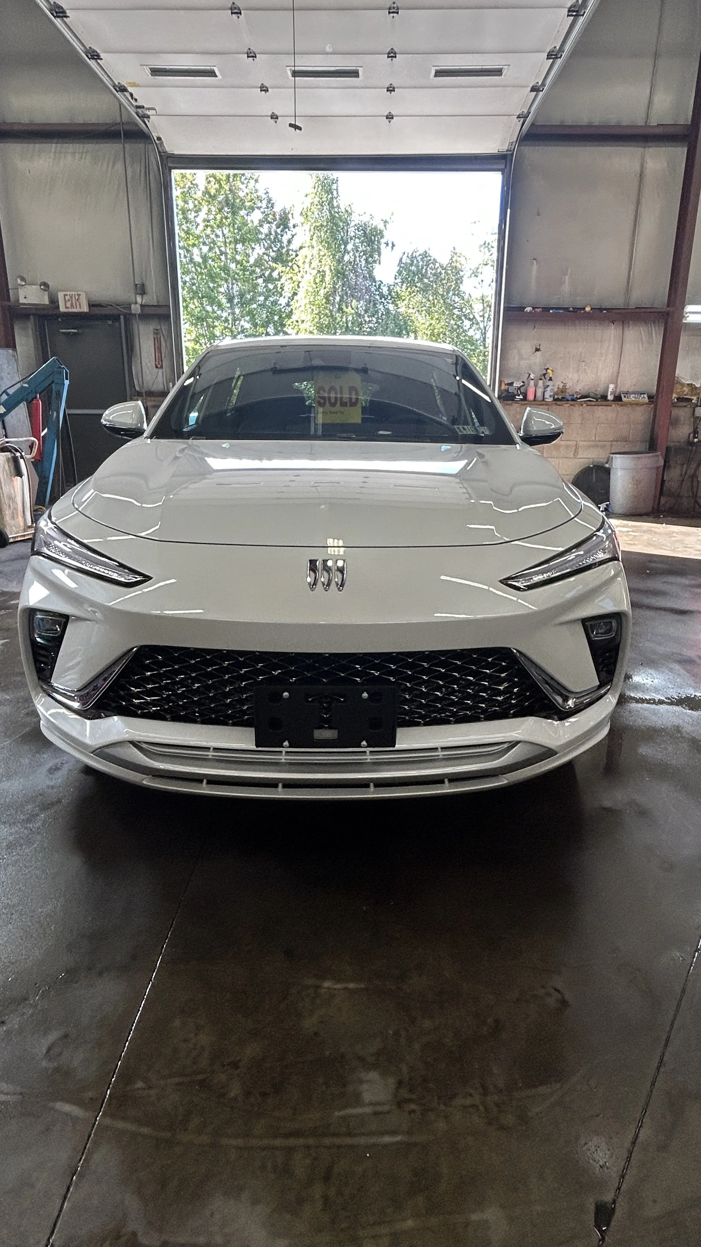 White car parked inside a garage with a 