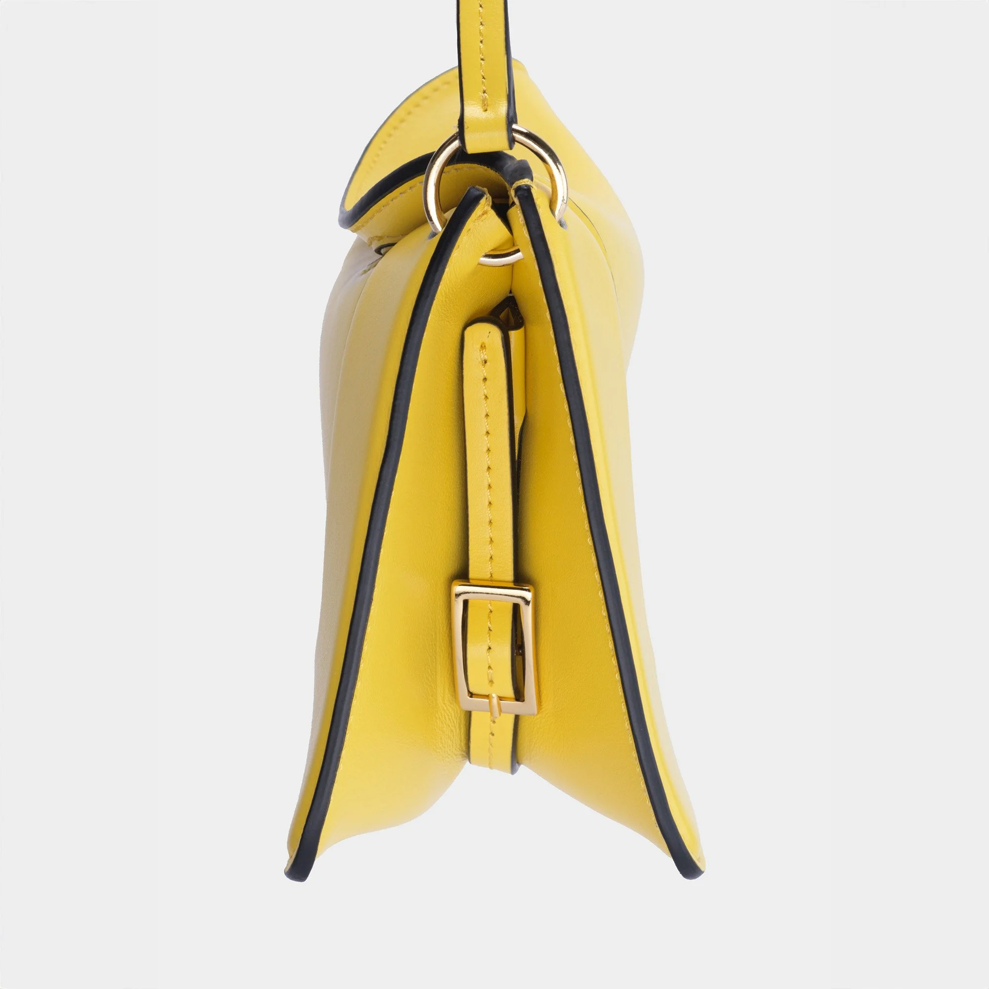 Side view of a yellow handbag with black accents and gold hardware, showing the side profile and strap buckle.