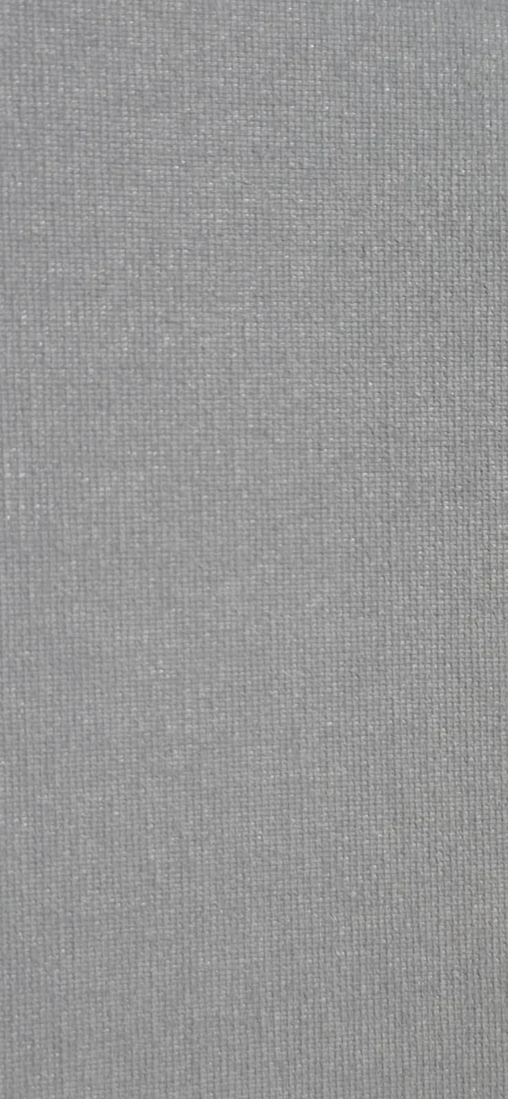 Close-up of grey fabric with a textured weave pattern.