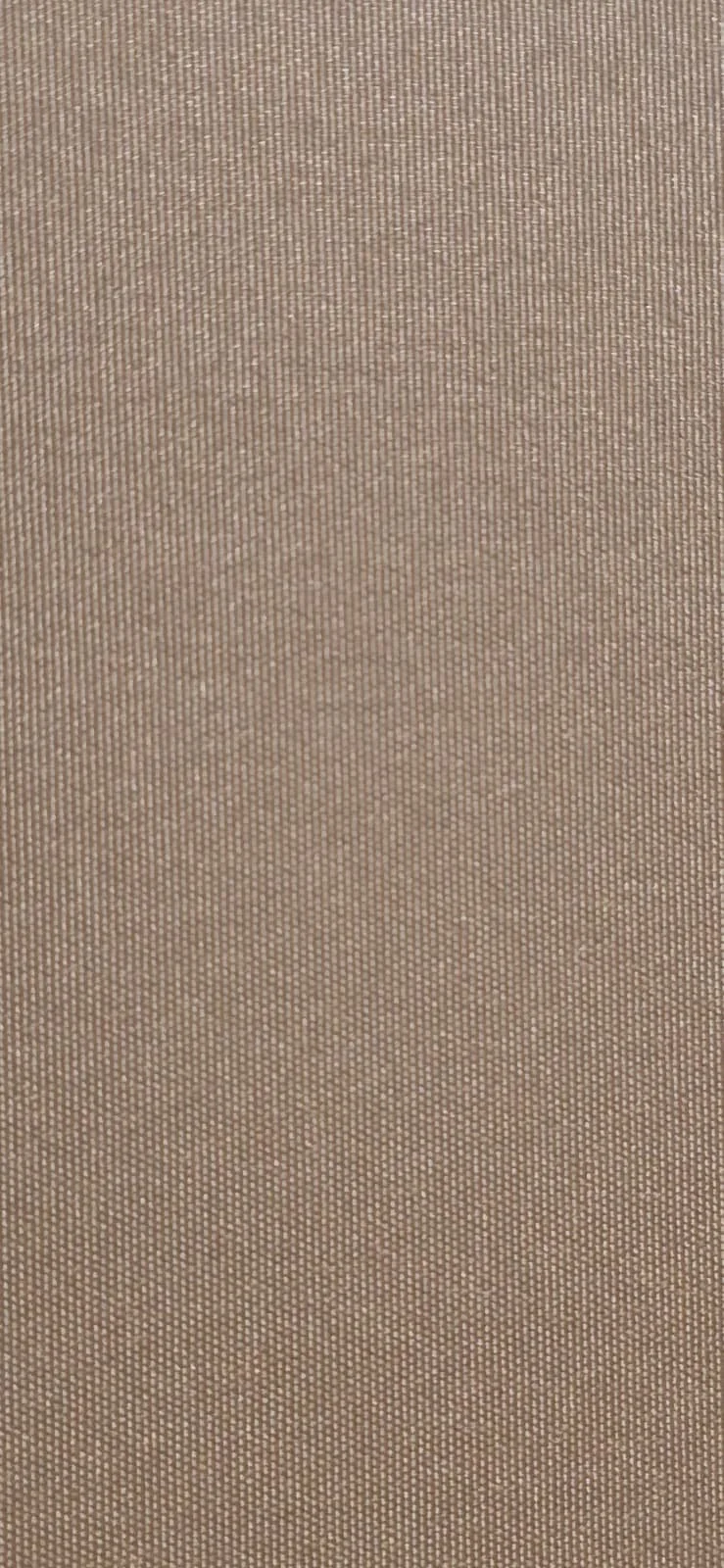 Close-up of beige textured fabric or material with small weave pattern.
