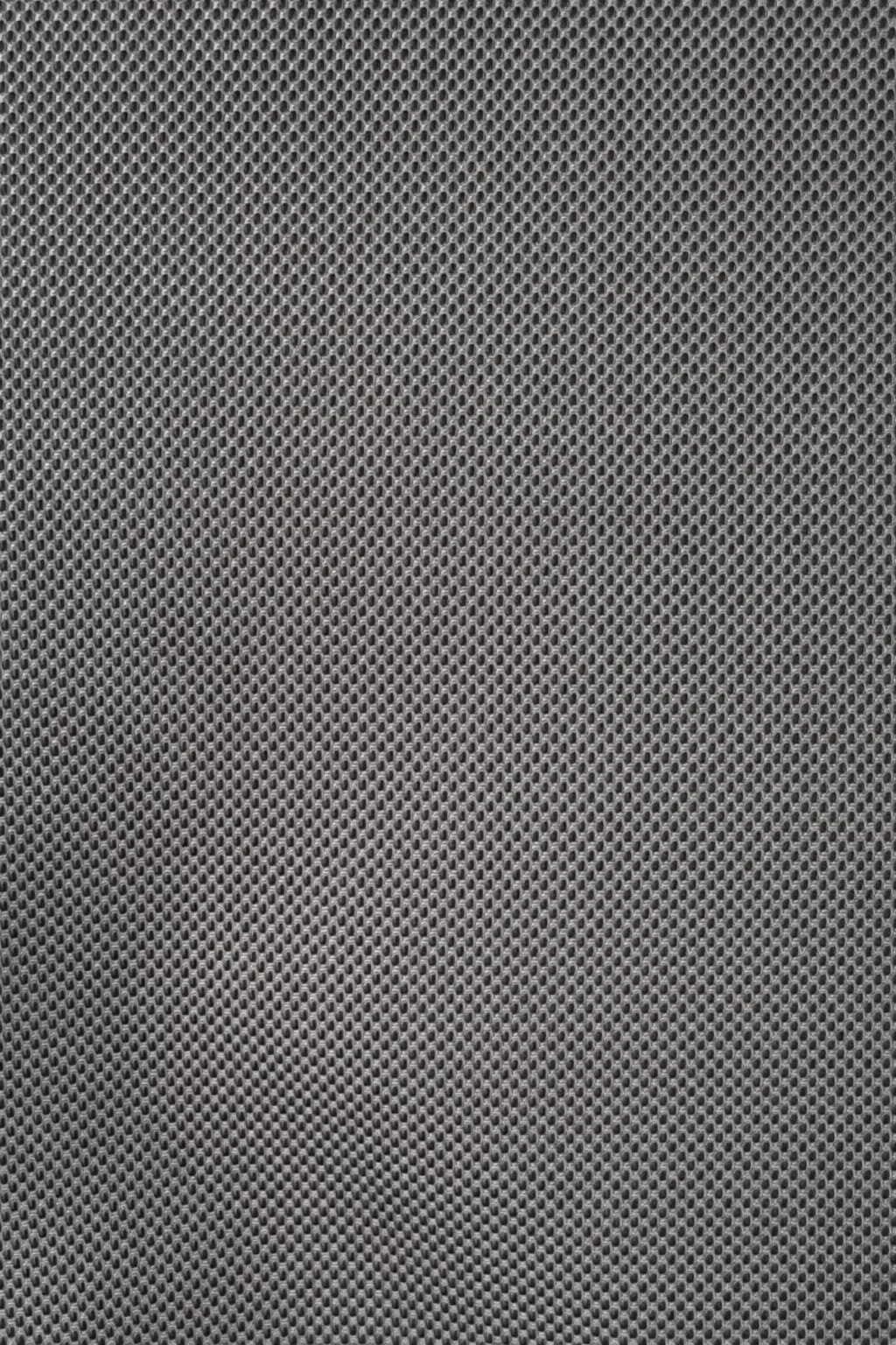 Close-up of a gray speaker grille with a pattern of small holes.