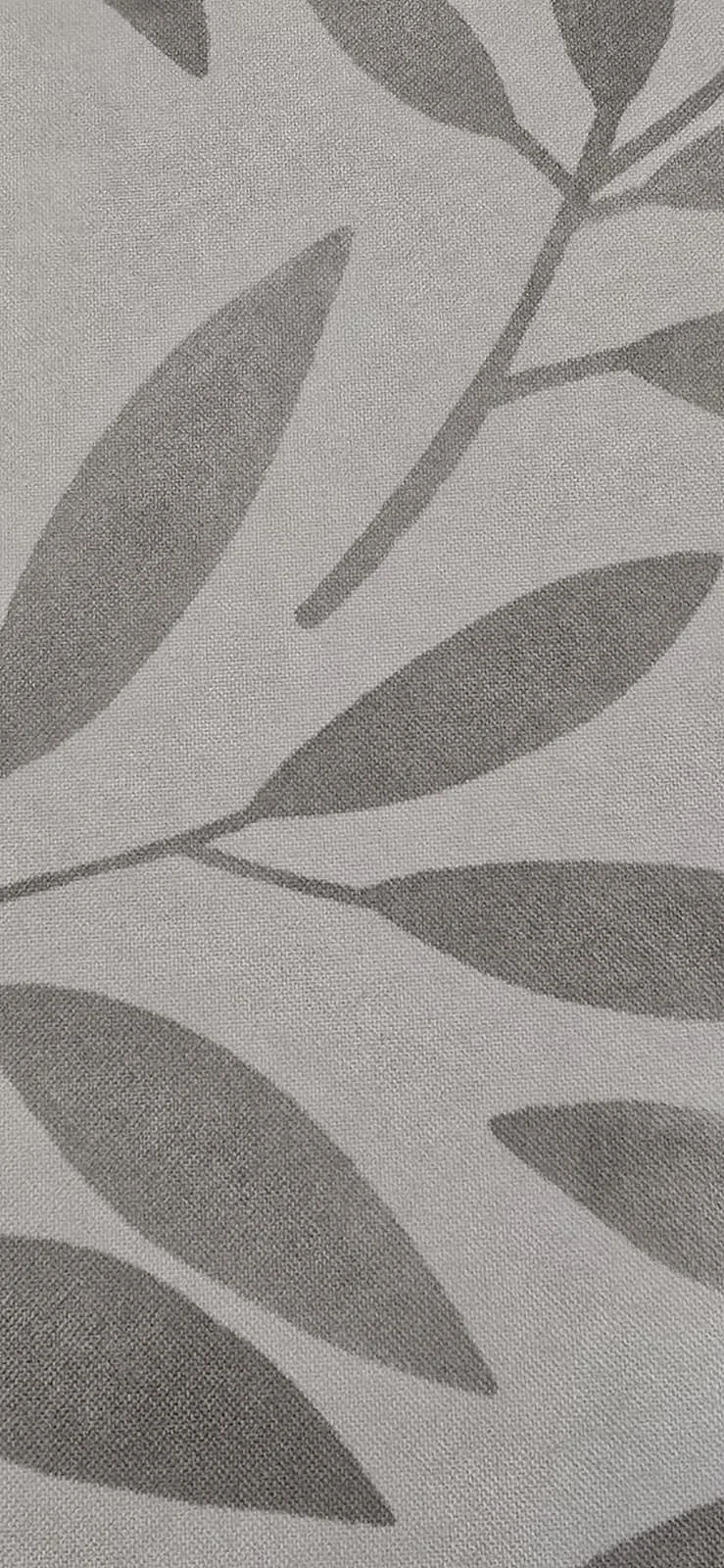 Close-up of fabric with a gray and white leaf pattern.