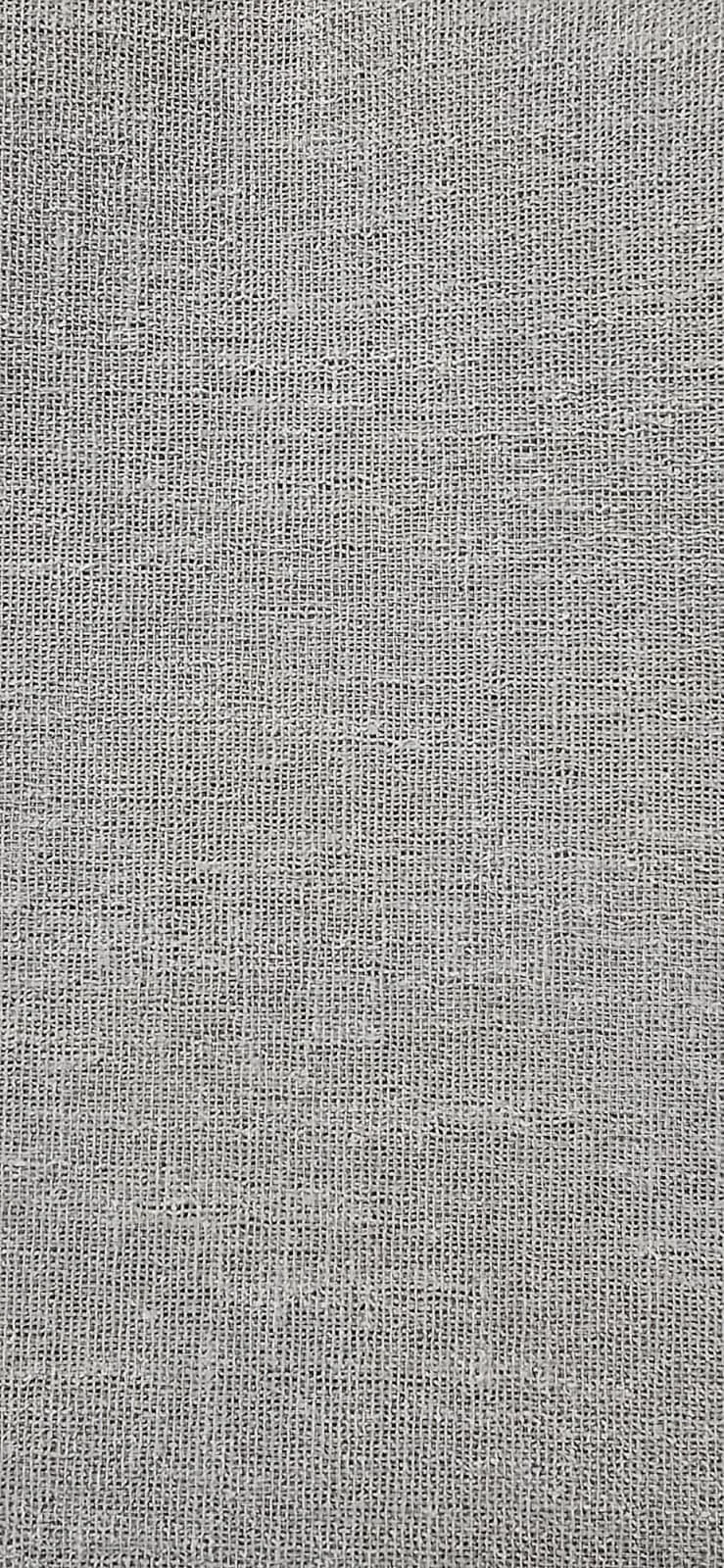 Close-up of a textured fabric surface with a woven pattern.
