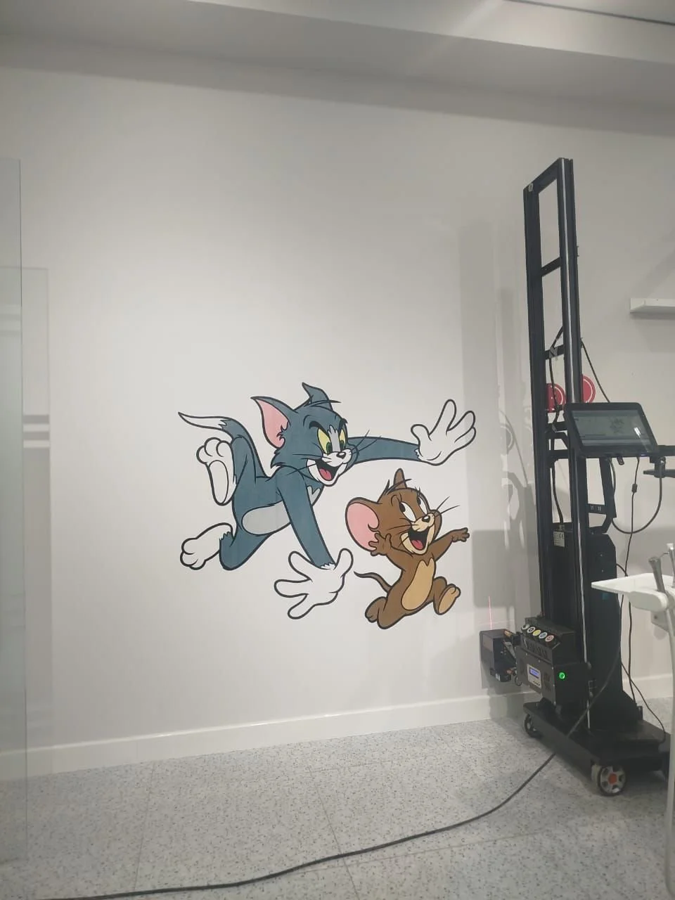 Wall mural featuring Tom and Jerry, iconic cartoon characters, with Tom reaching out and Jerry walking happily.