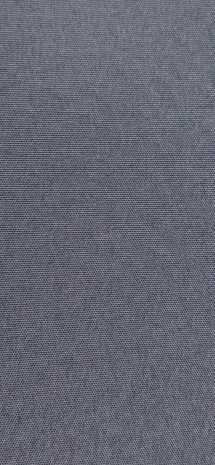 Close-up of gray textured fabric with tiny white dotted pattern.