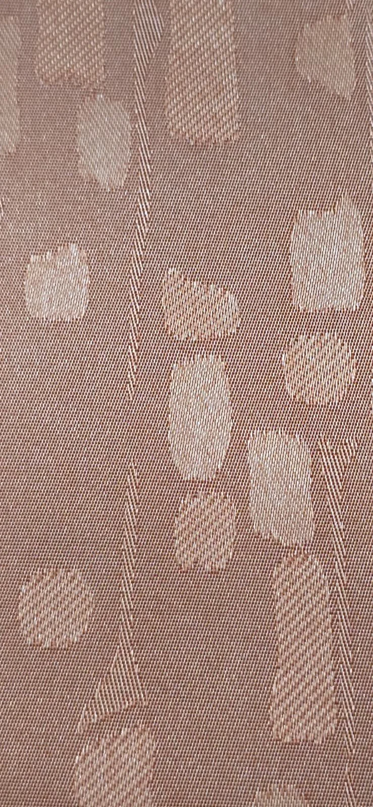 Close-up of a fabric with a geometric pattern featuring various shapes like rectangles, circles, and squares in a tan and beige color scheme.