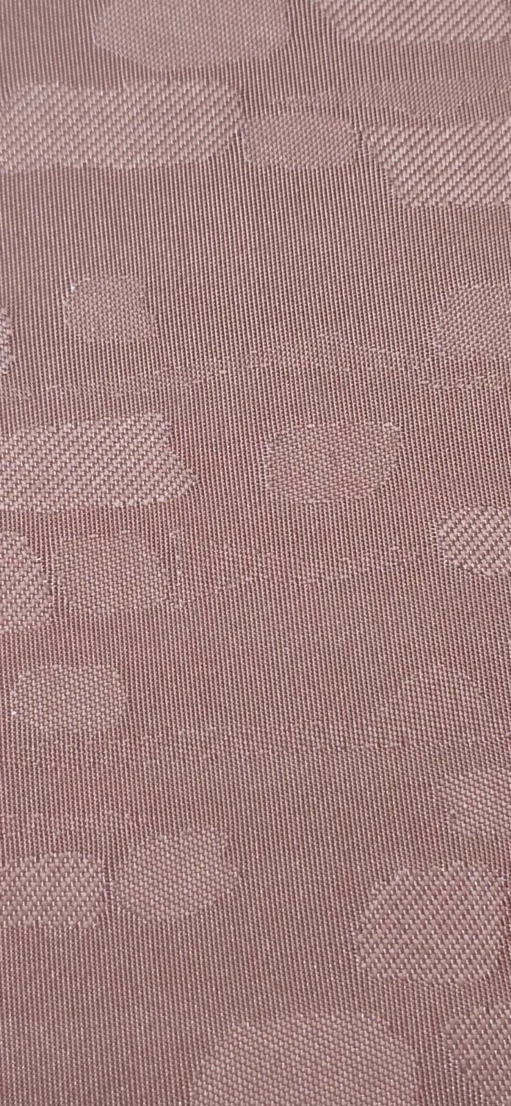 Close-up of pink fabric with a floral pattern woven into the material.