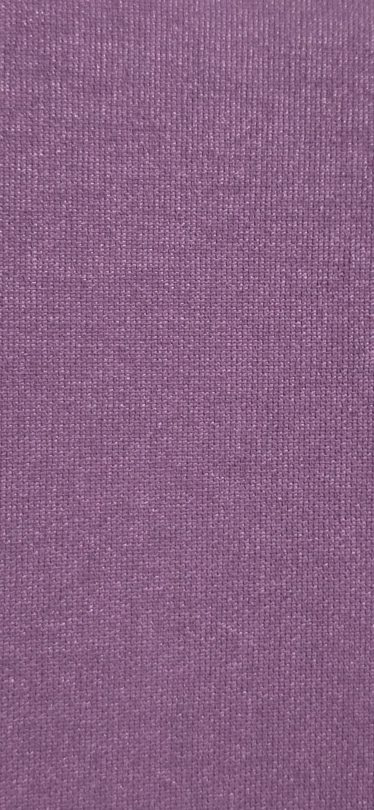 Close-up of a purple fabric or textile with a textured weave pattern.