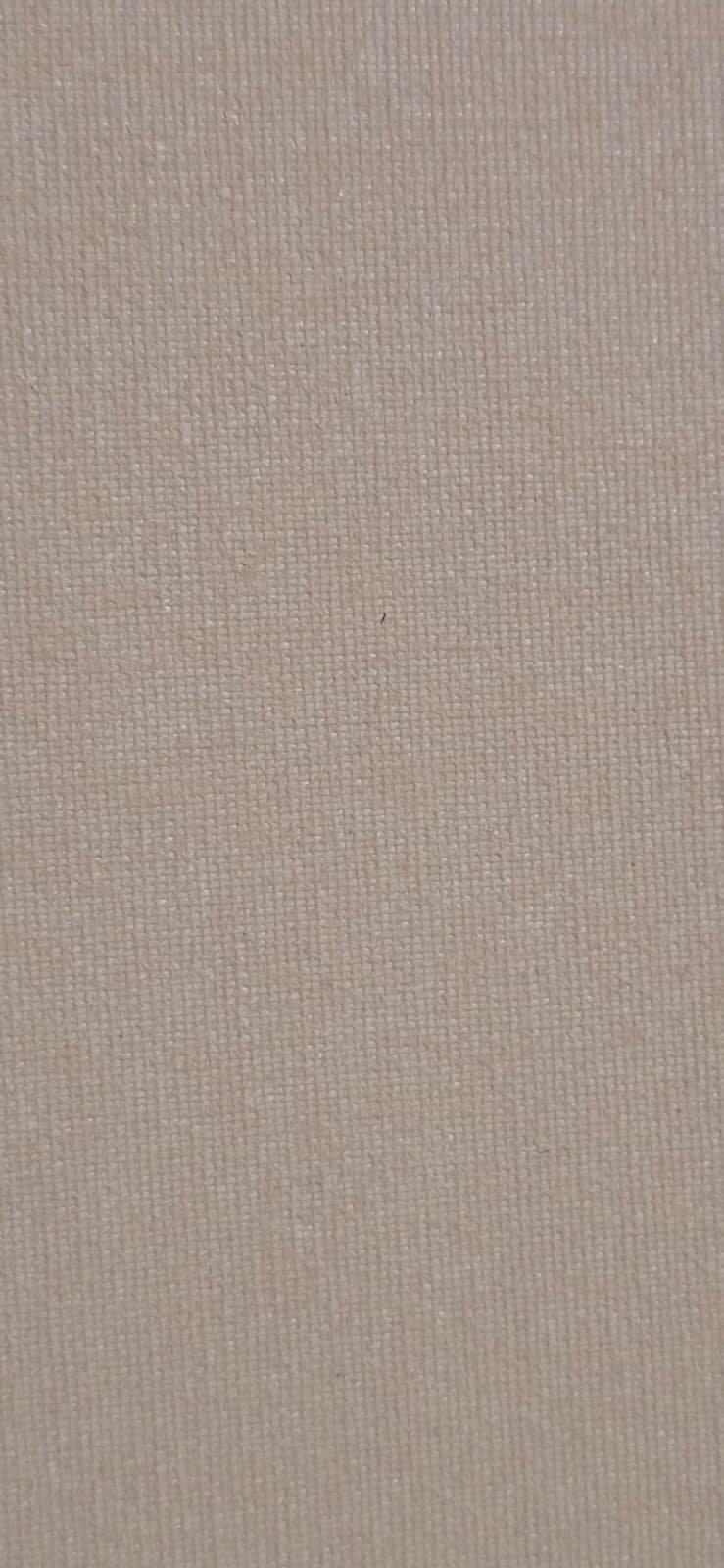 Close-up image of a beige or light tan textured fabric surface.