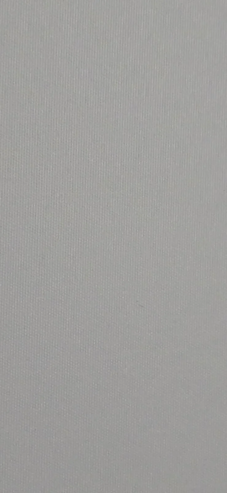 Close-up of a gray textured surface, possibly a fabric or material with tiny ridges or dots.