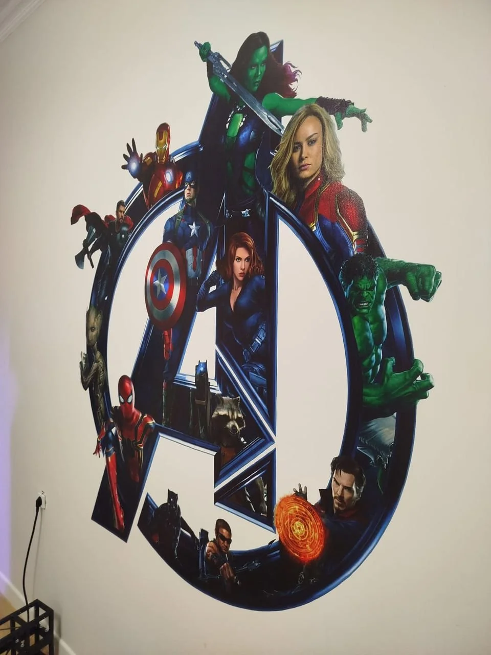 Decorative wall poster featuring Marvel superheroes including Captain Marvel, the Hulk, Black Widow, Thor, Iron Man, Black Panther, Spider-Man, Rocket Raccoon, War Machine, and Doctor Strange arranged around a large Avengers logo.
