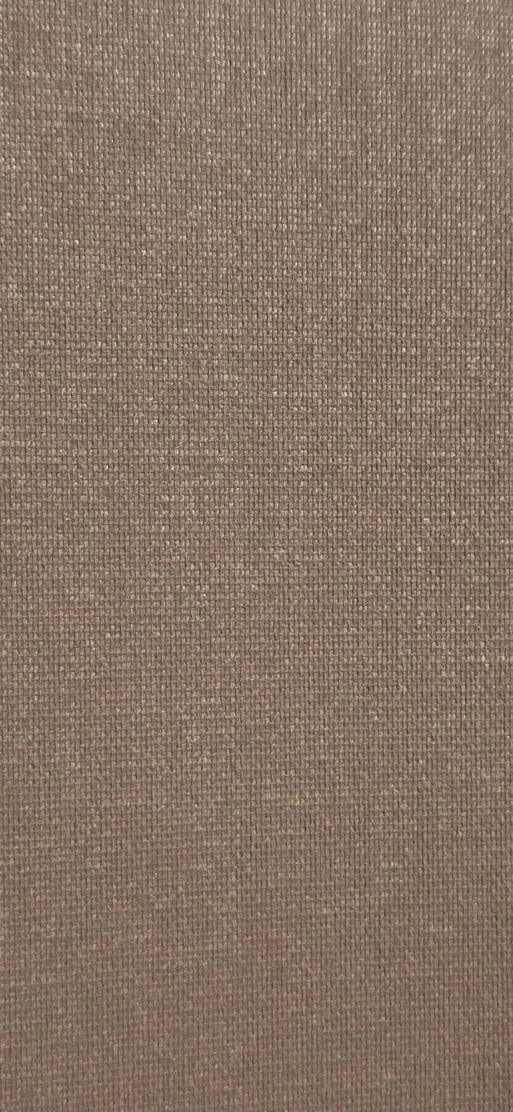 Close-up of a beige textured fabric surface.