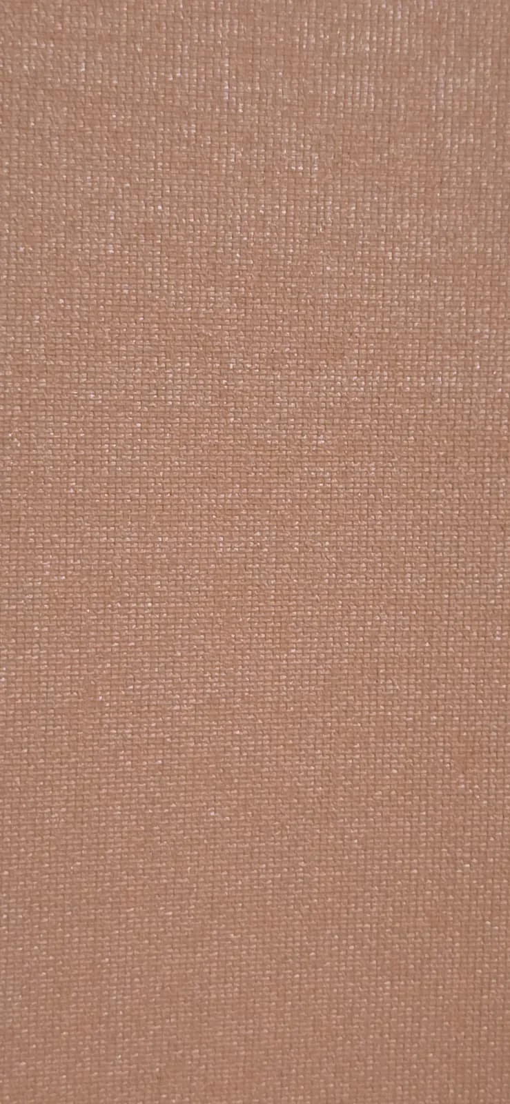 Close-up view of a textured, light brown fabric surface