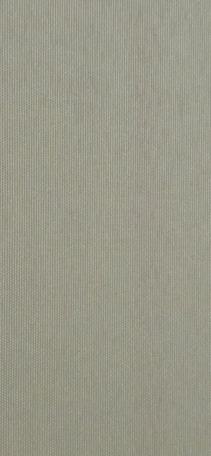 Close-up of a textured, light-colored fabric surface.