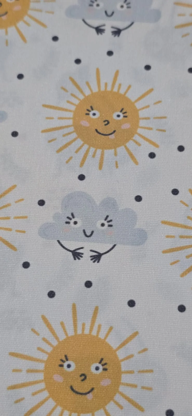 Pattern of cartoon smiling suns and clouds with faces, arms, and blushing cheeks, on a light background.