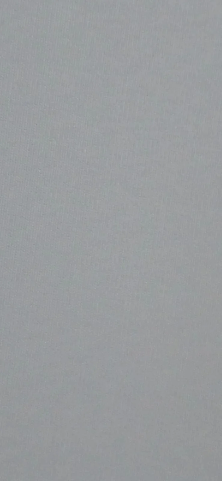 Close-up of a gray textured surface, possibly a wall or fabric.