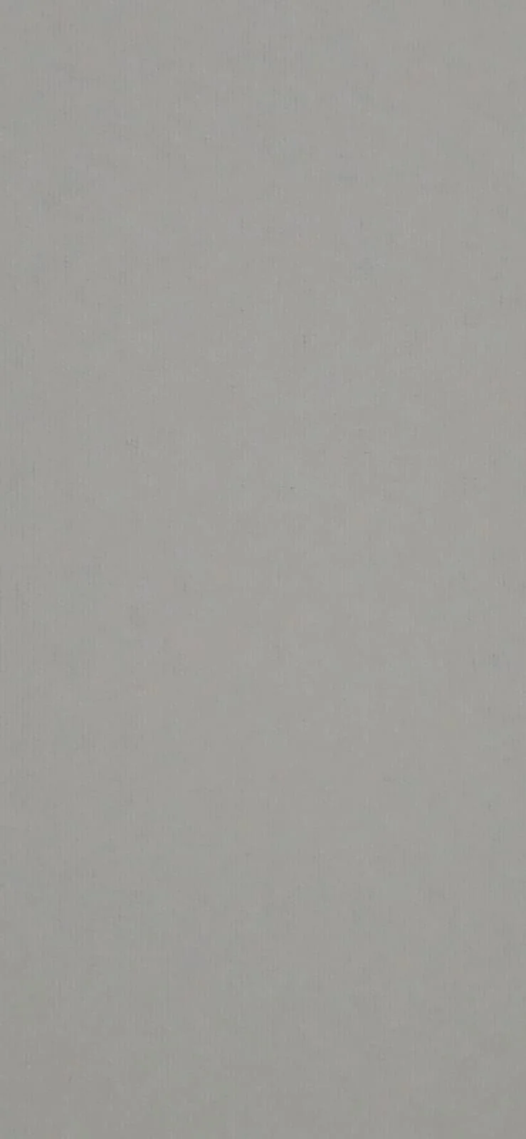 A plain, textured, light-colored wall or surface with no objects or markings.