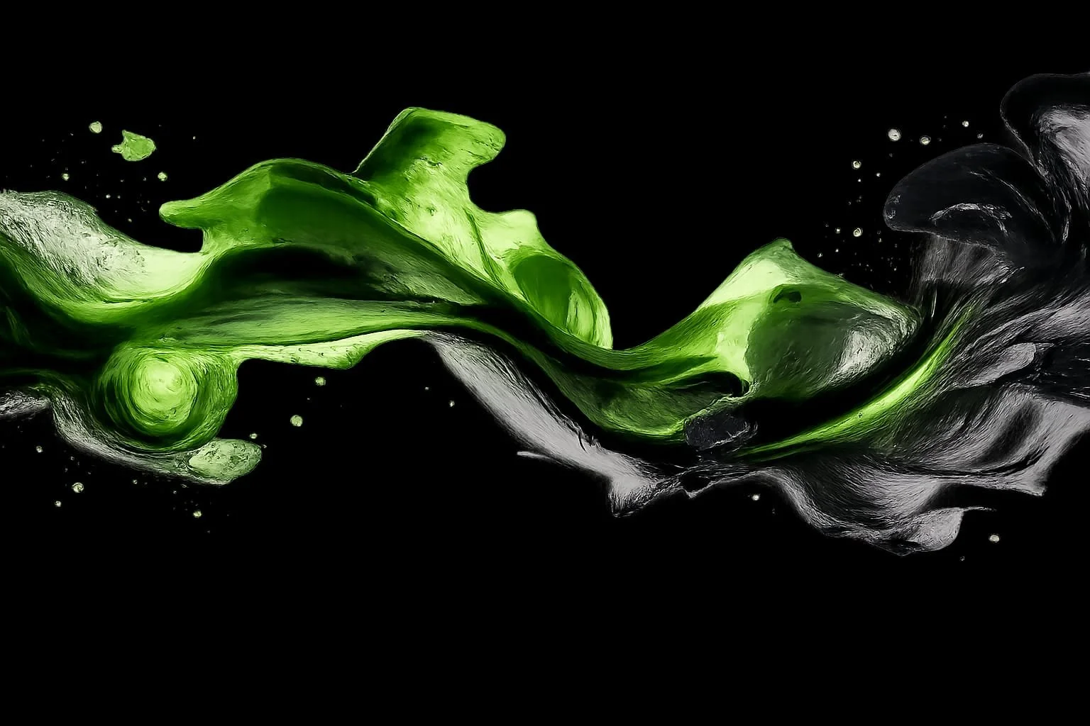 Abstract green and black paint splash on a black background.