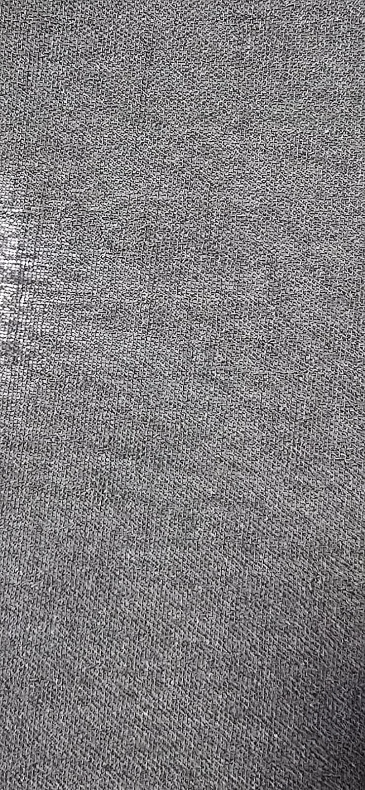 Close-up of a gray textured fabric surface.