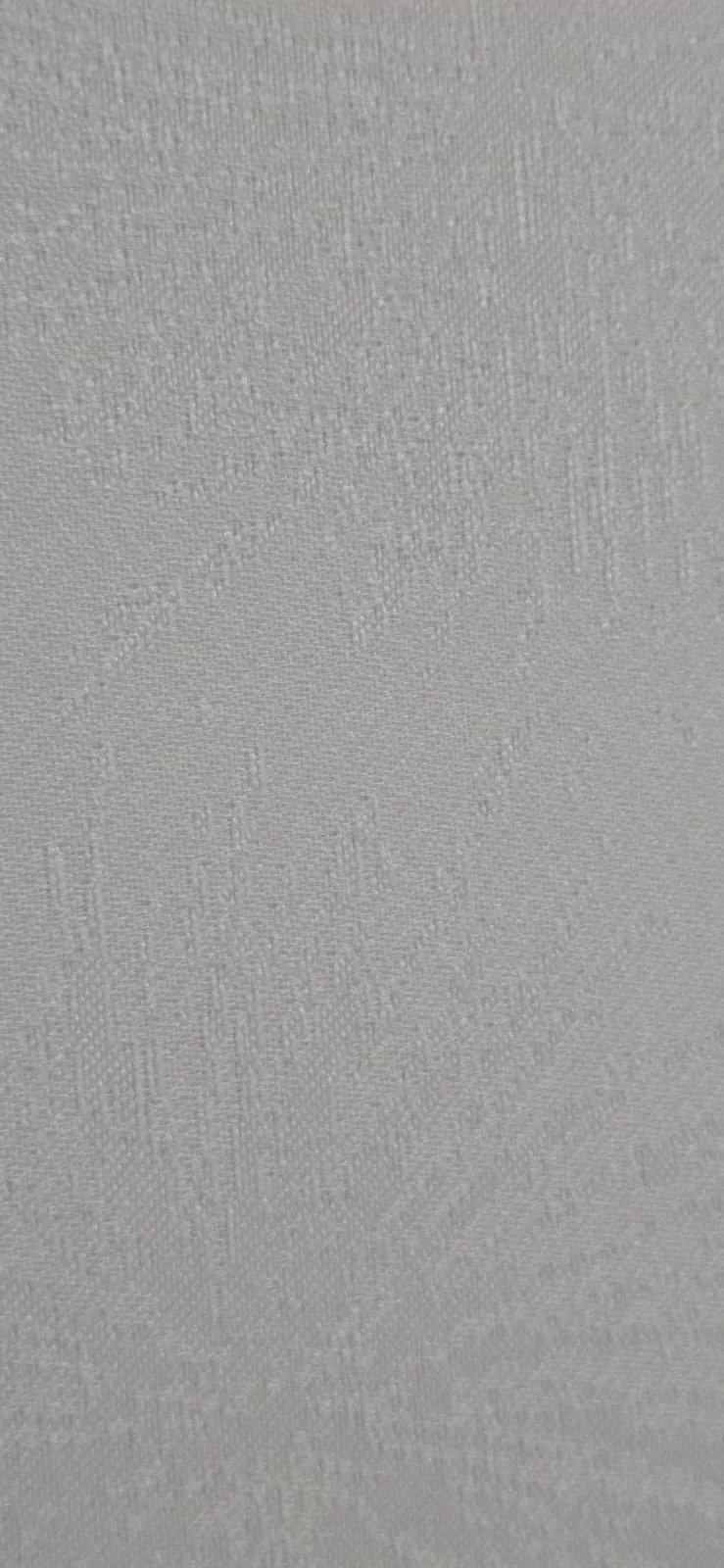 Close-up of a textured surface, possibly fabric or paper.