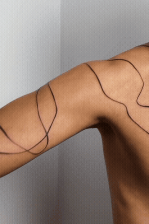 Freehand abstract line tattoo on skin by tattoo artist Amador Z