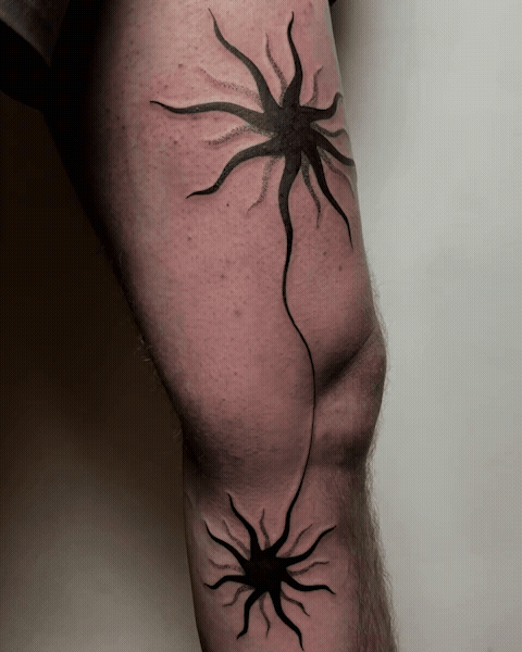 Abstract black sun tattoo on leg by tattoo artist Amador Z
