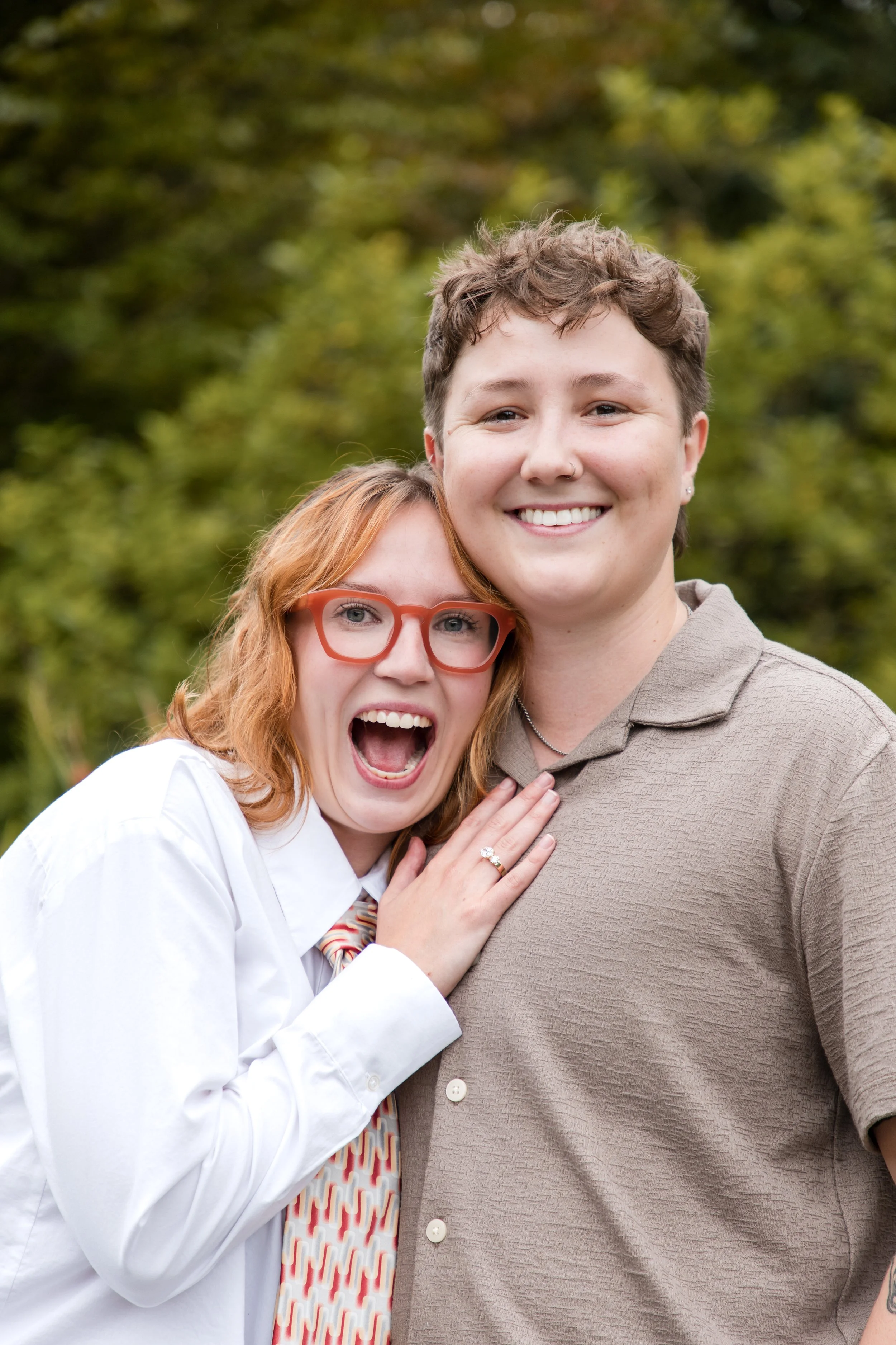 Joyful couple moments after a surprise proposal in a garden