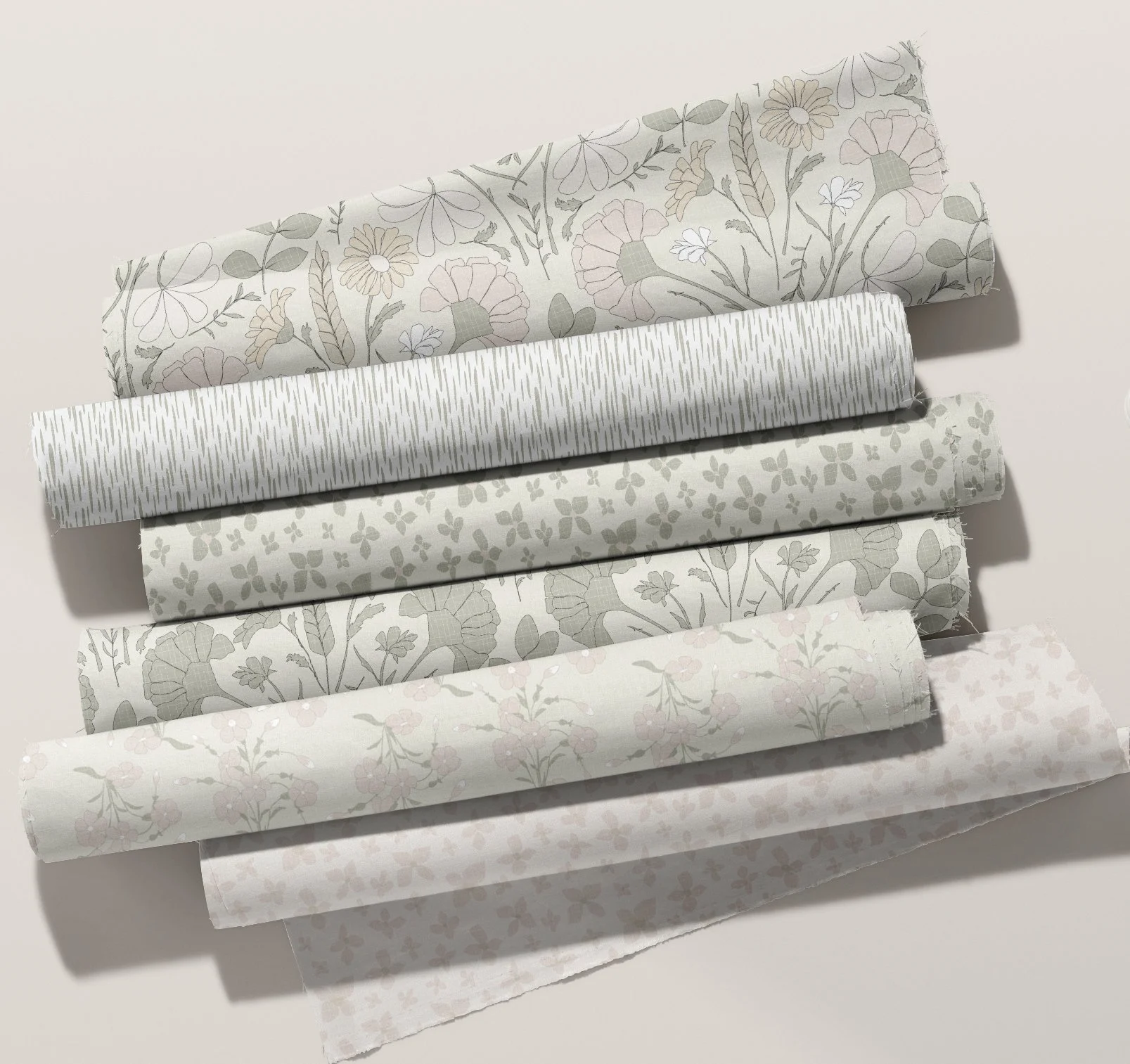 Five rolls of decorative wrapping paper with floral and striped patterns, arranged in a row on a white surface.