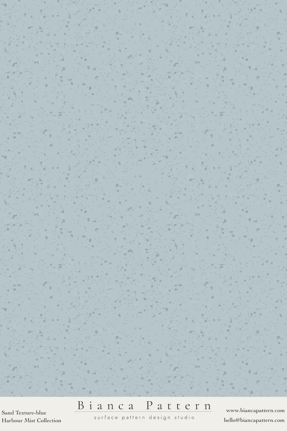 A light blue textured pattern with darker speckles, resembling a sand surface with small pebbles.