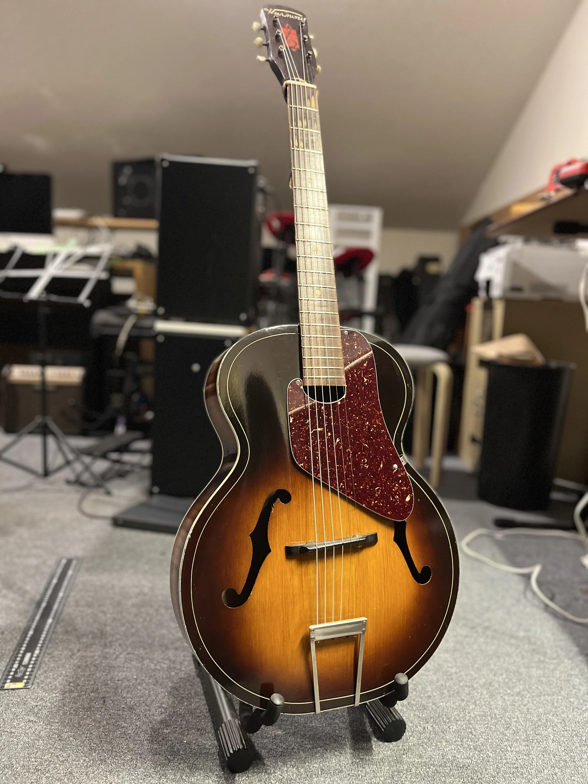 I was really pleased with the look and sound of this vintage Harmony when it left! Neck reset, custom pickguard, new bone nut, and lots of love.
