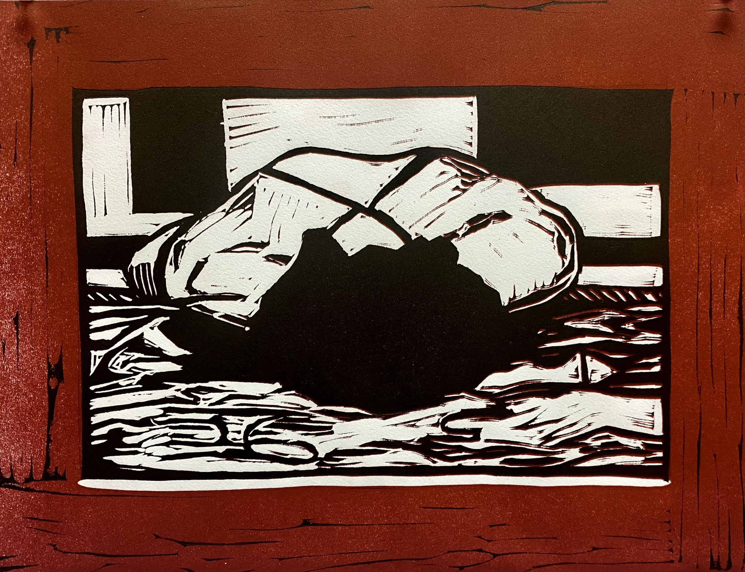 An abstract black and white print, with red background of a person laying face-first on the ground, with dark hair spread out.