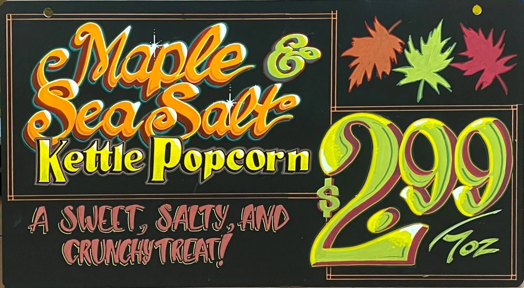 Colorful end-cap sign advertising kettle popcorn for $2.99, with fall leaves illustrations, and the phrase "A sweet, salty, and crunchy treat!"
