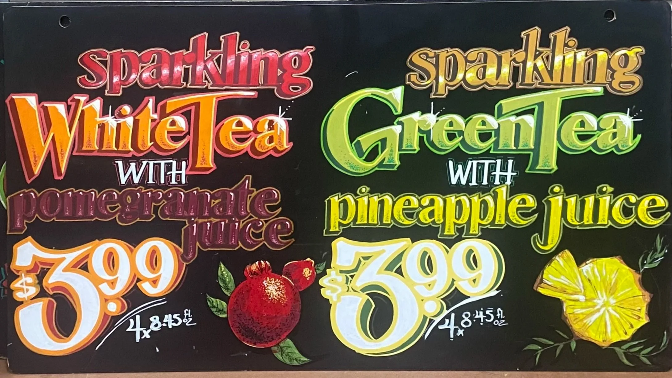 Colorful end-cap sign advertising sparkling white and green teas with fruit, showing prices of $3.99 for four, with illustrations of a pomegranate and pineapple.