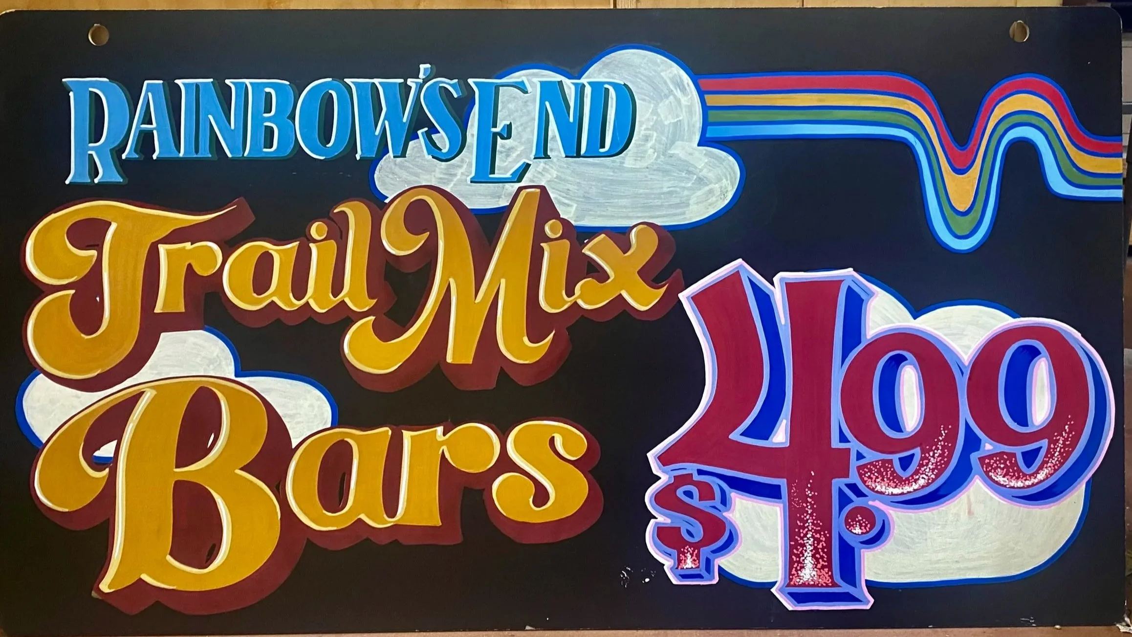 Colorful end-cap sign for Rainbow's End Trail Mix Bars with bright lettering, rainbow design, clouds, and large price of 4.99