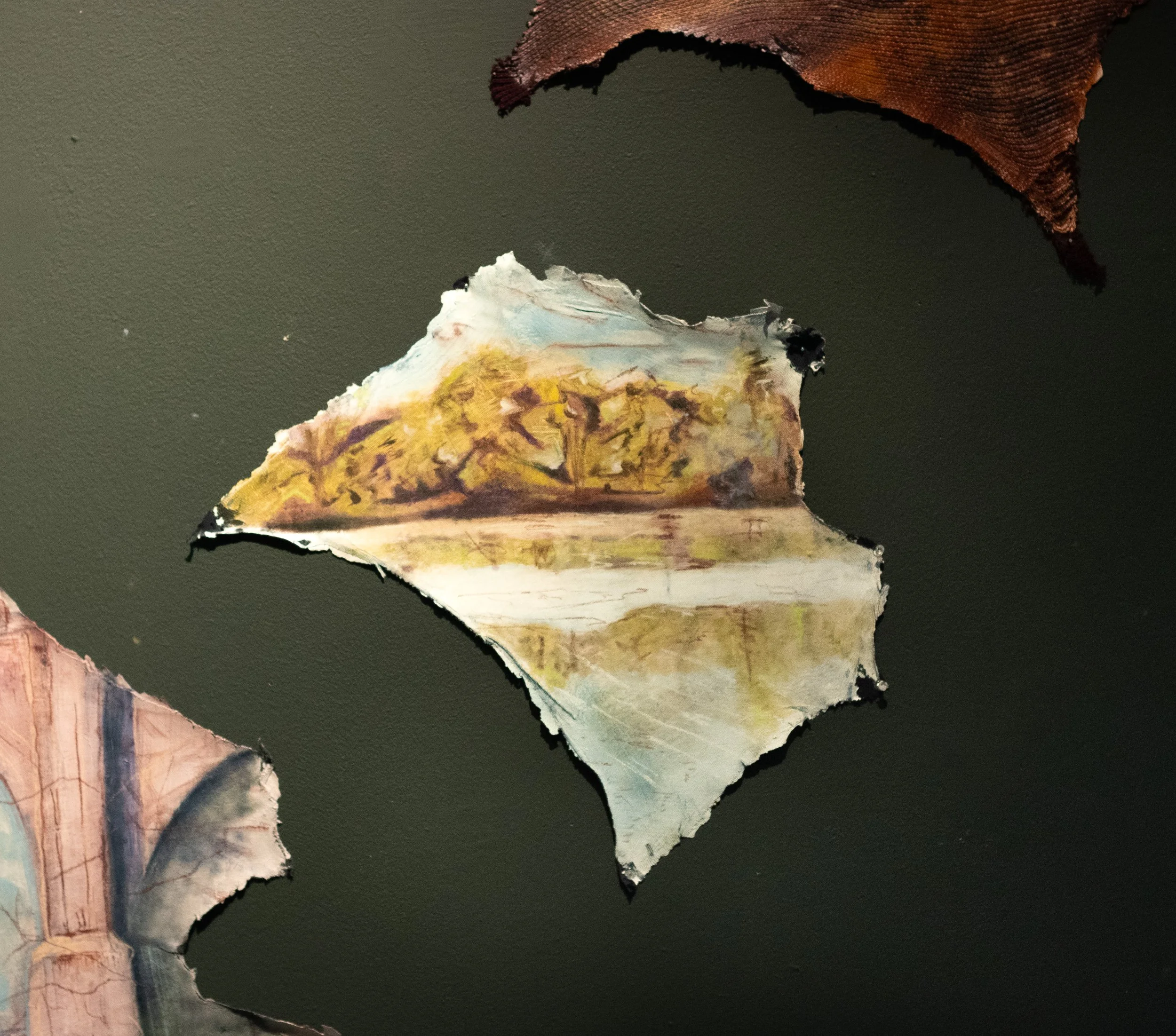 Torn paper with landscape painting of trees and a water body