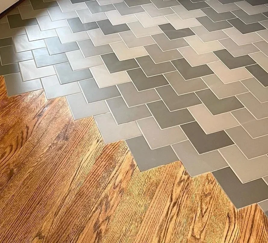 Transition from wooden flooring to herringbone patterned tile flooring. Heartwood Renovations. West Hartford, CT