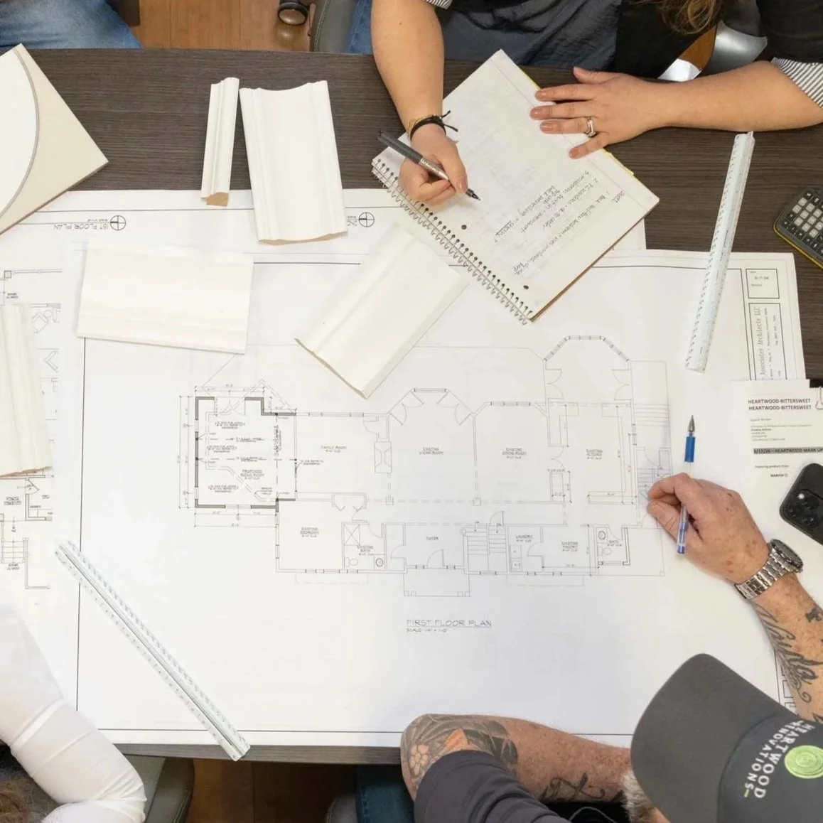 Heartwood Renovations crew marking up a floor plan for a Central Connecticut home remodel