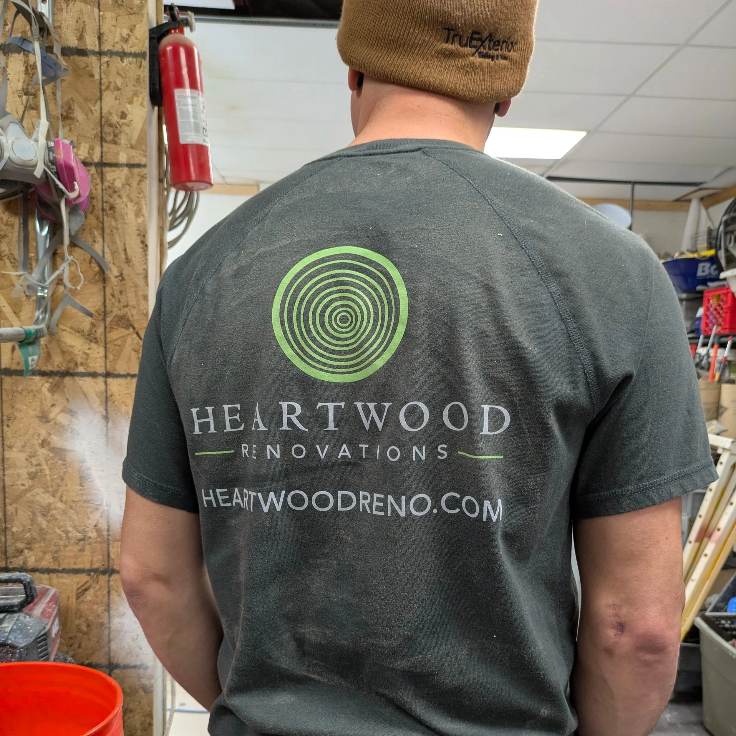 Heartwood Renovations crew member in a branded shirt in the company woodshop, West Hartford, CT
