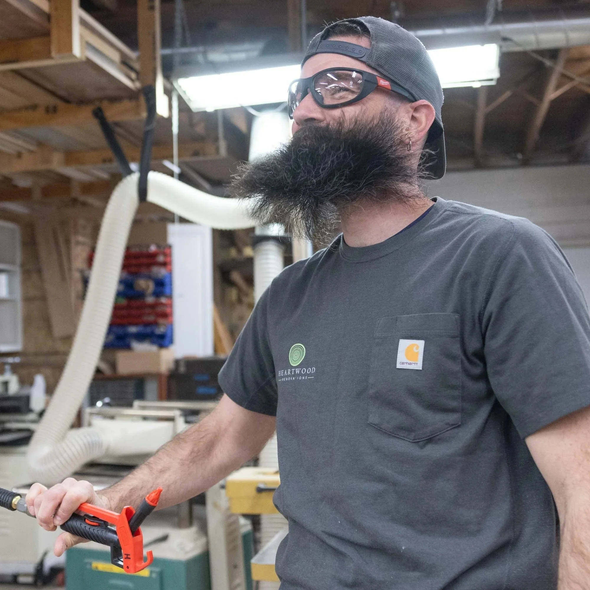 Heartwood woodworker in safety glasses cutting stock in the West Hartford, CT shop
