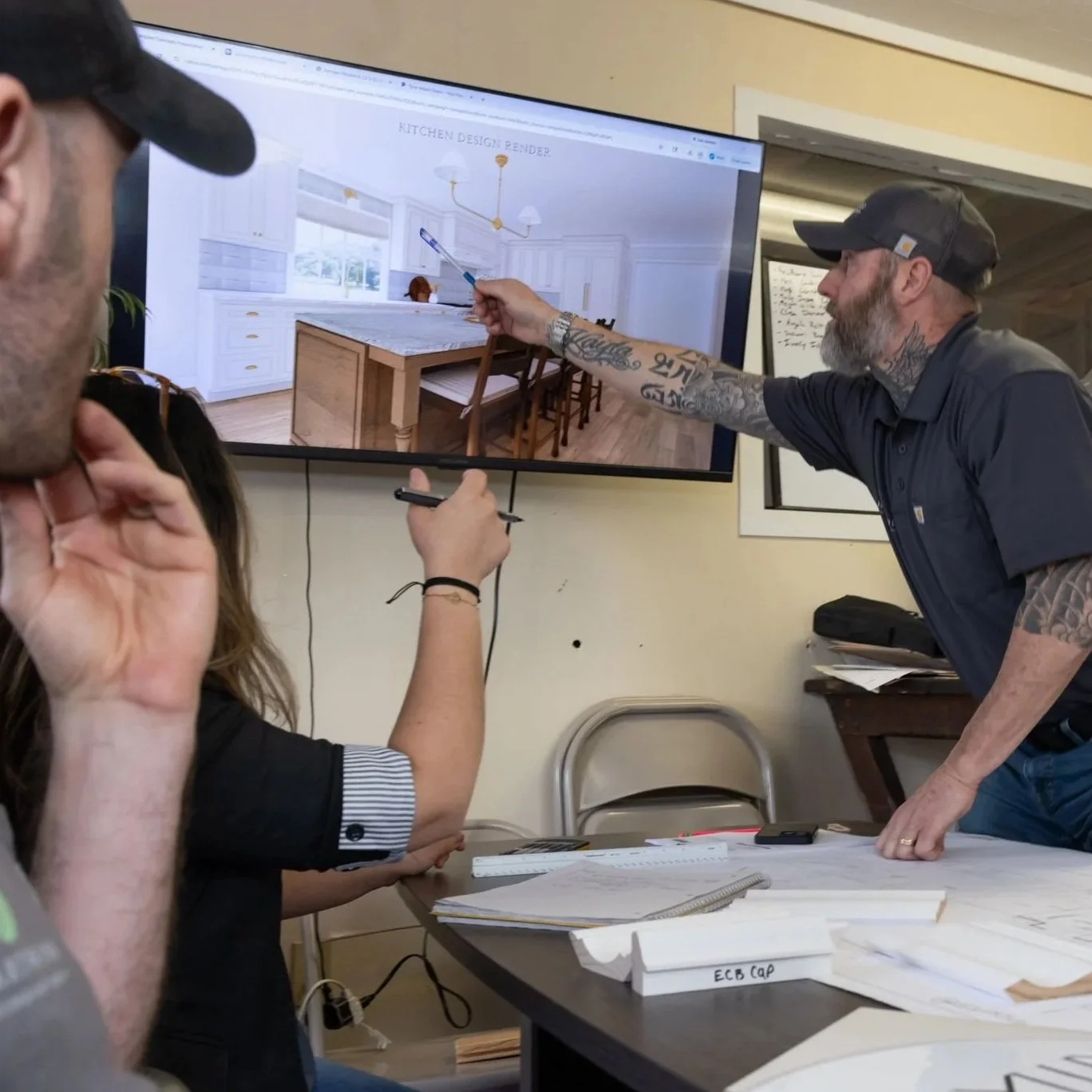 Heartwood Renovations team reviewing a 3D remodel design on screen during a project meeting
