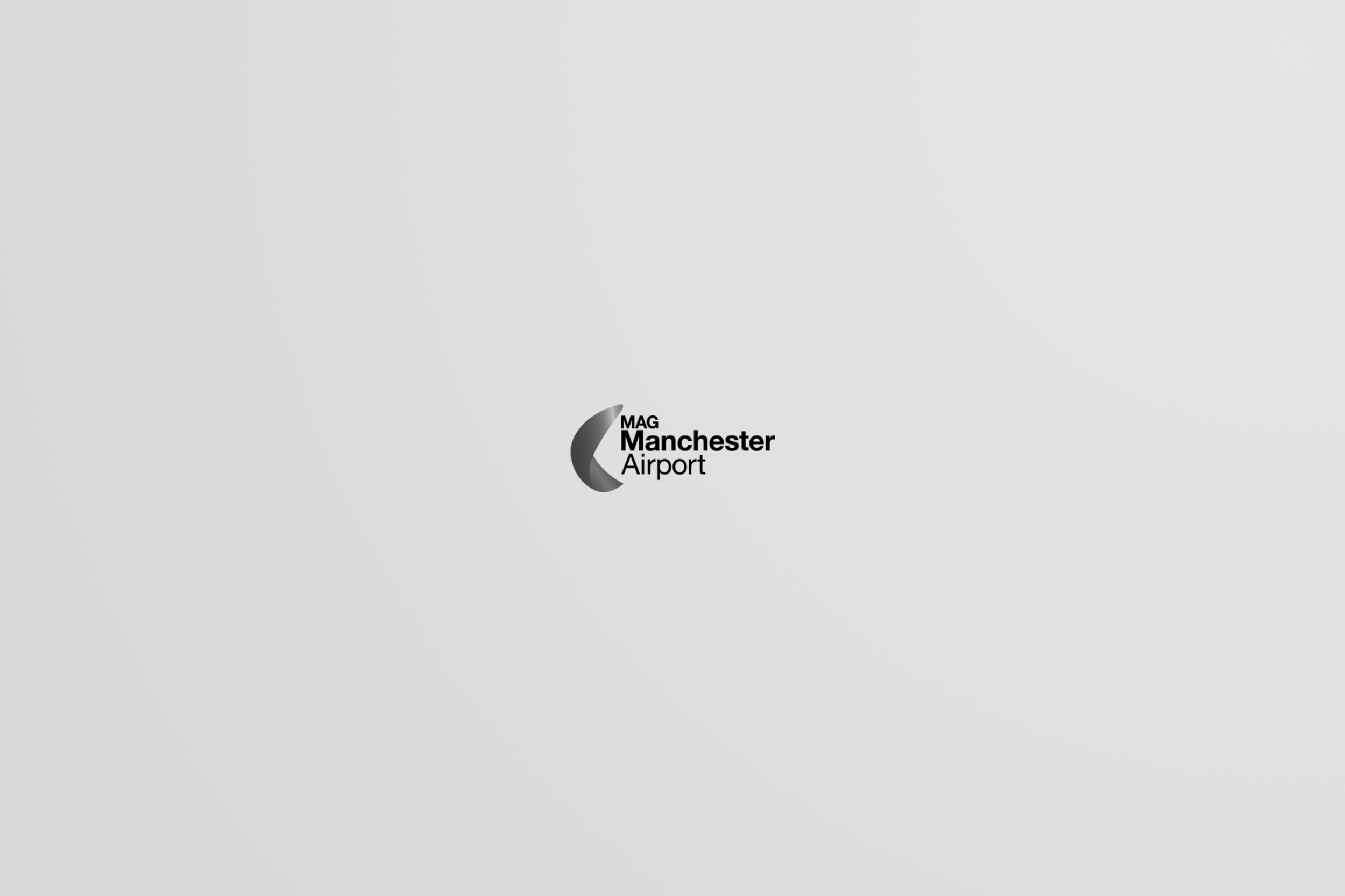 Manchester Airport logo with a black and gray crescent shape and the text 'MAG Manchester Airport' on a plain gray background.