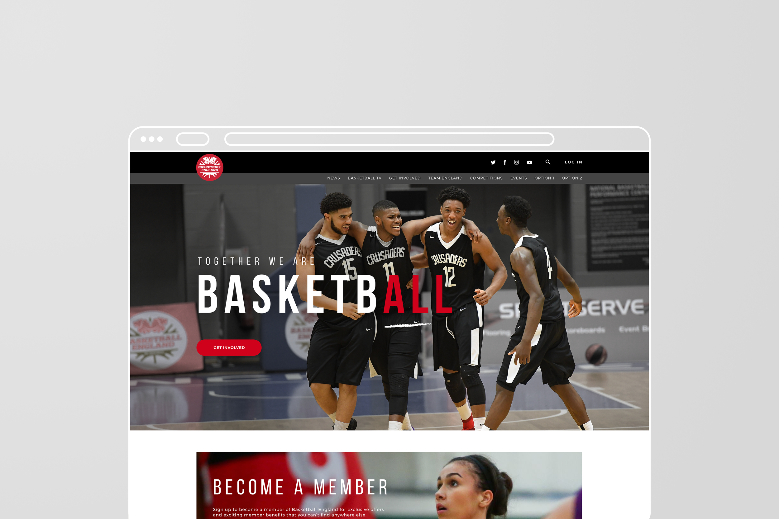 Four young male basketball players in black jerseys celebrating on indoor basketball court.