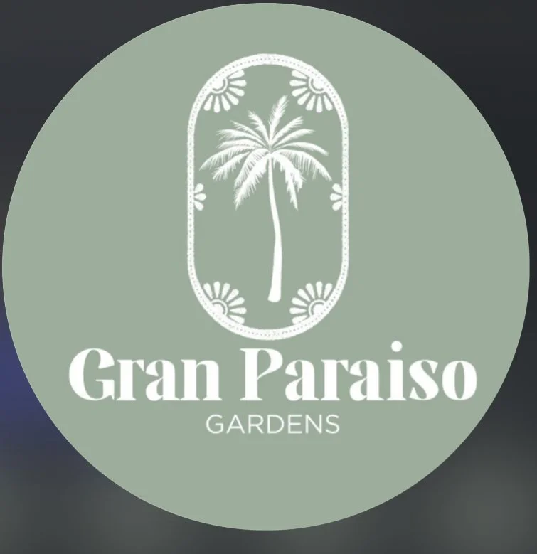 Logo for Gran Paraíso Gardens with a palm tree illustration inside a decorative frame.