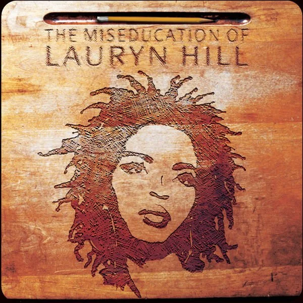 Wooden cover with a portrait outline of Lauryn Hill's face and the text "The Miseducation of Lauryn Hill" at the top, with a pencil at the top of the cover.