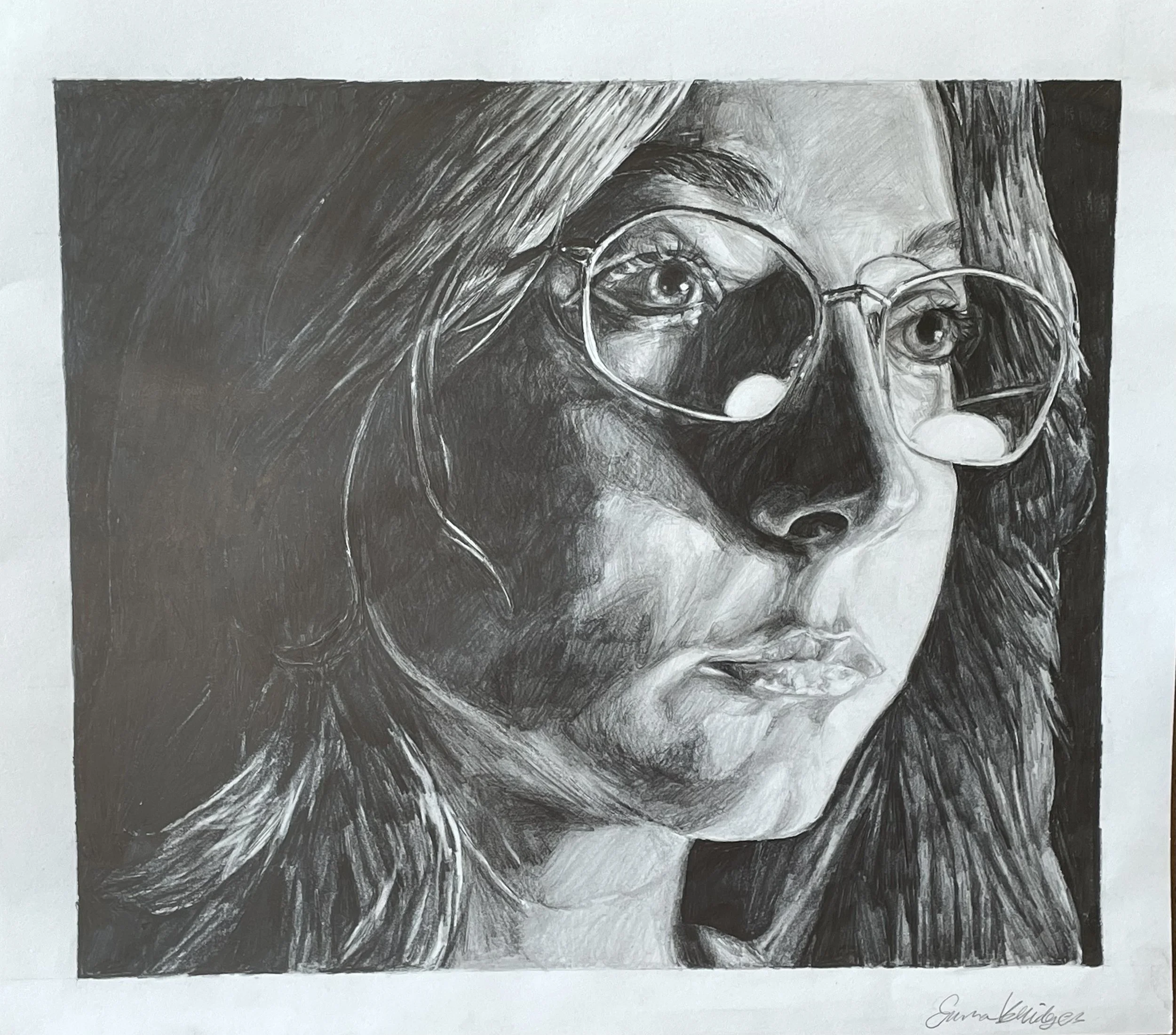 Black and white close-up portrait of a woman with long hair, wearing glasses, with detailed shading highlighting her facial features and reflections in her glasses.
