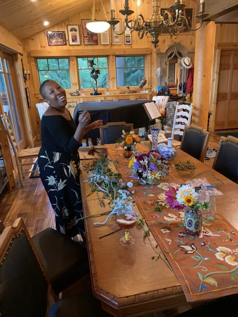Sunny making flower arrangements at a large wooden table