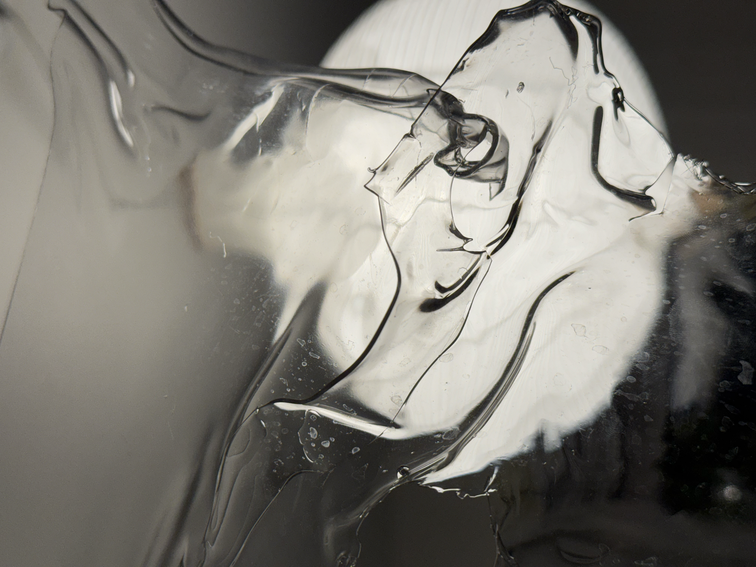 Close-up photograph of melting ice with visible cracks and water droplets.